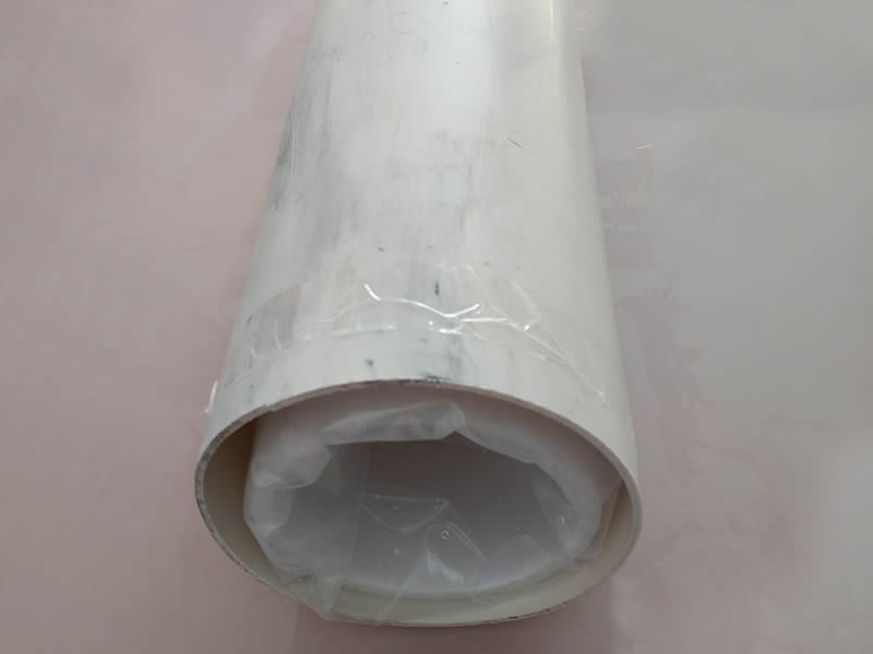 There is a detail photo PFSA proton exchange membrane roll in a cylinder.